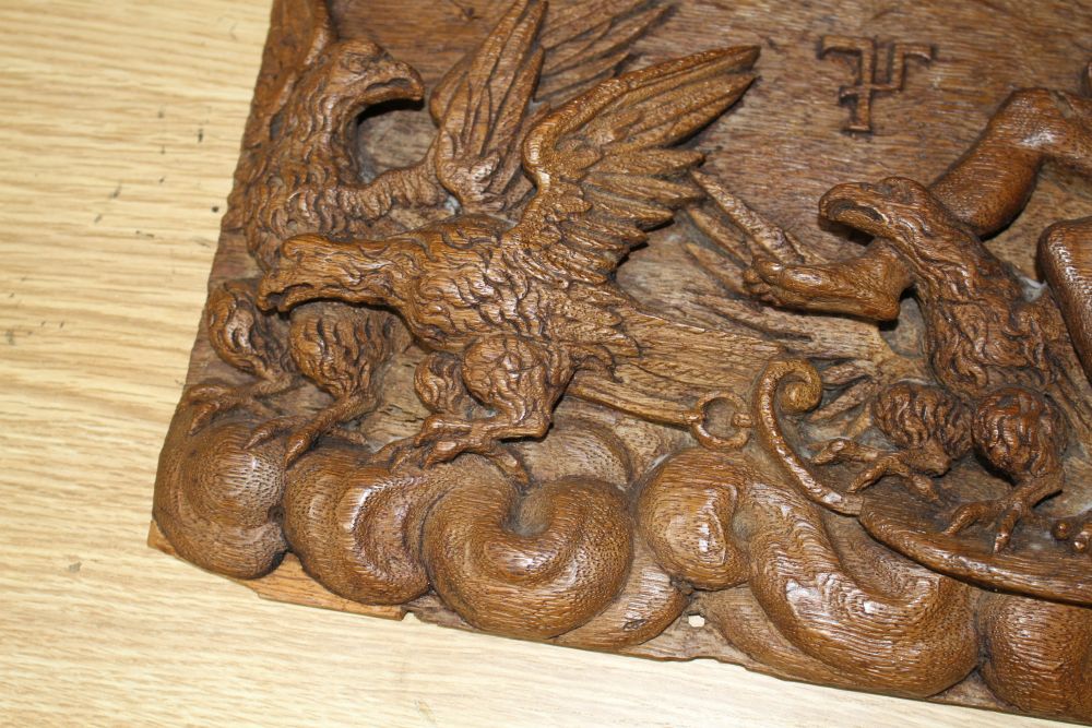 A 19th century Continental relief carved oak plaque depicting Jupiter riding in a chariot pulled by eagles, 25 x 34cm